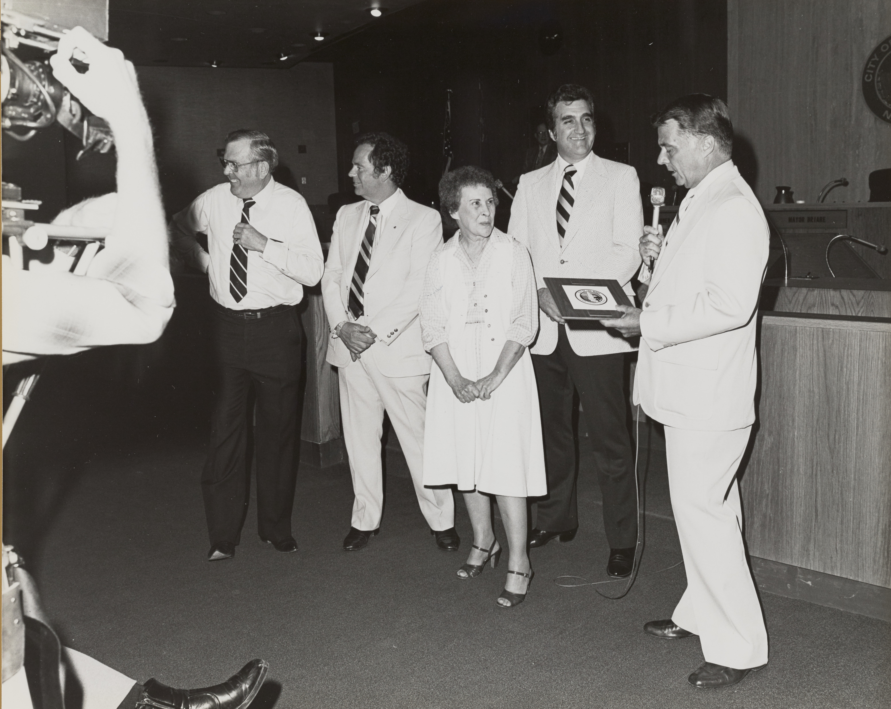 Photograph of Mayor Briare, Ron Lurie and others giving retirement award to Ila Britt, Director for the Department of Business Activity, September 2, 1981