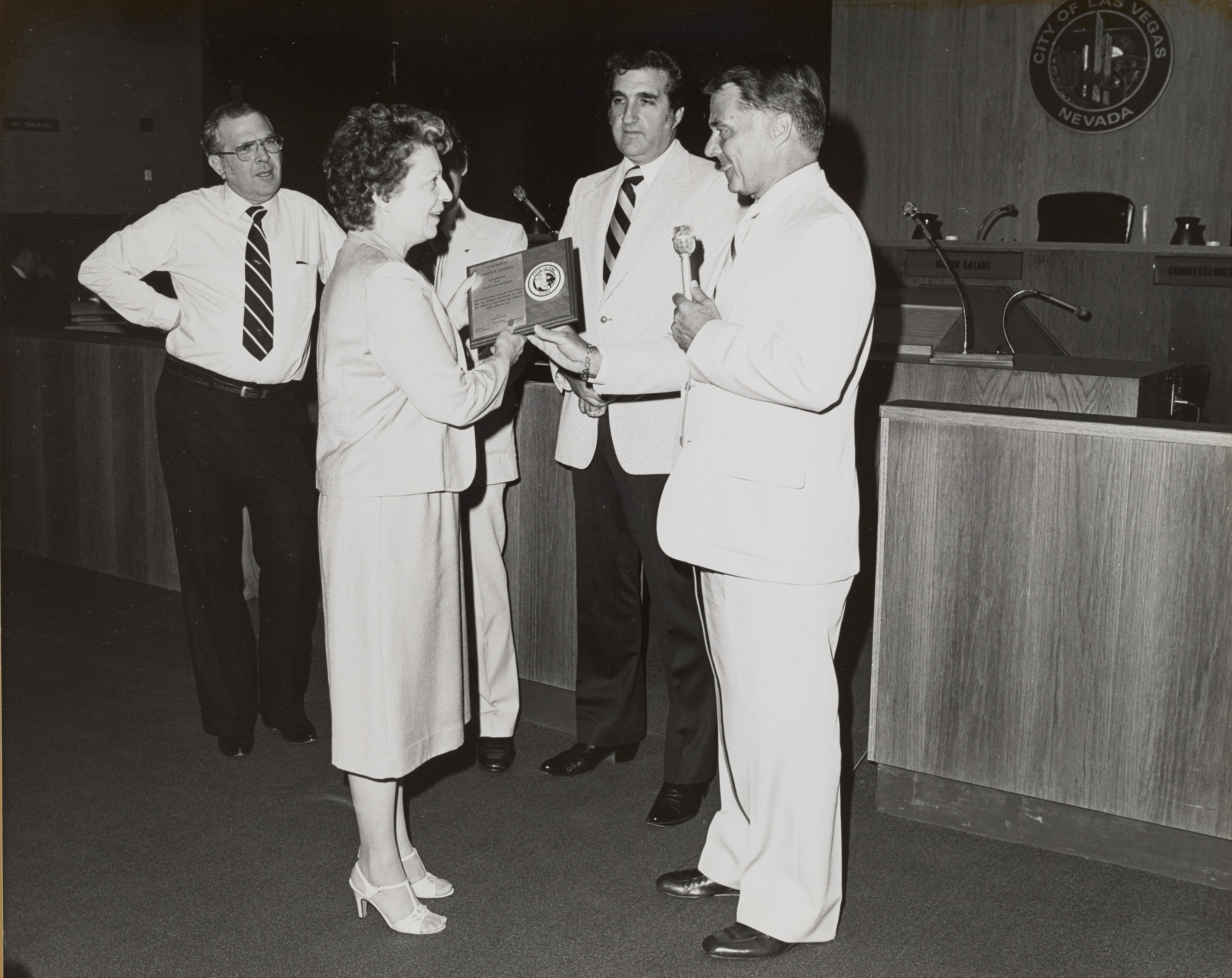 Photograph of Mayor Briare, Ron Lurie and others giving plaque to Mrs. Joseph Swessel for her husband's service on the Planning Commission and Board of Zoning Adjustment