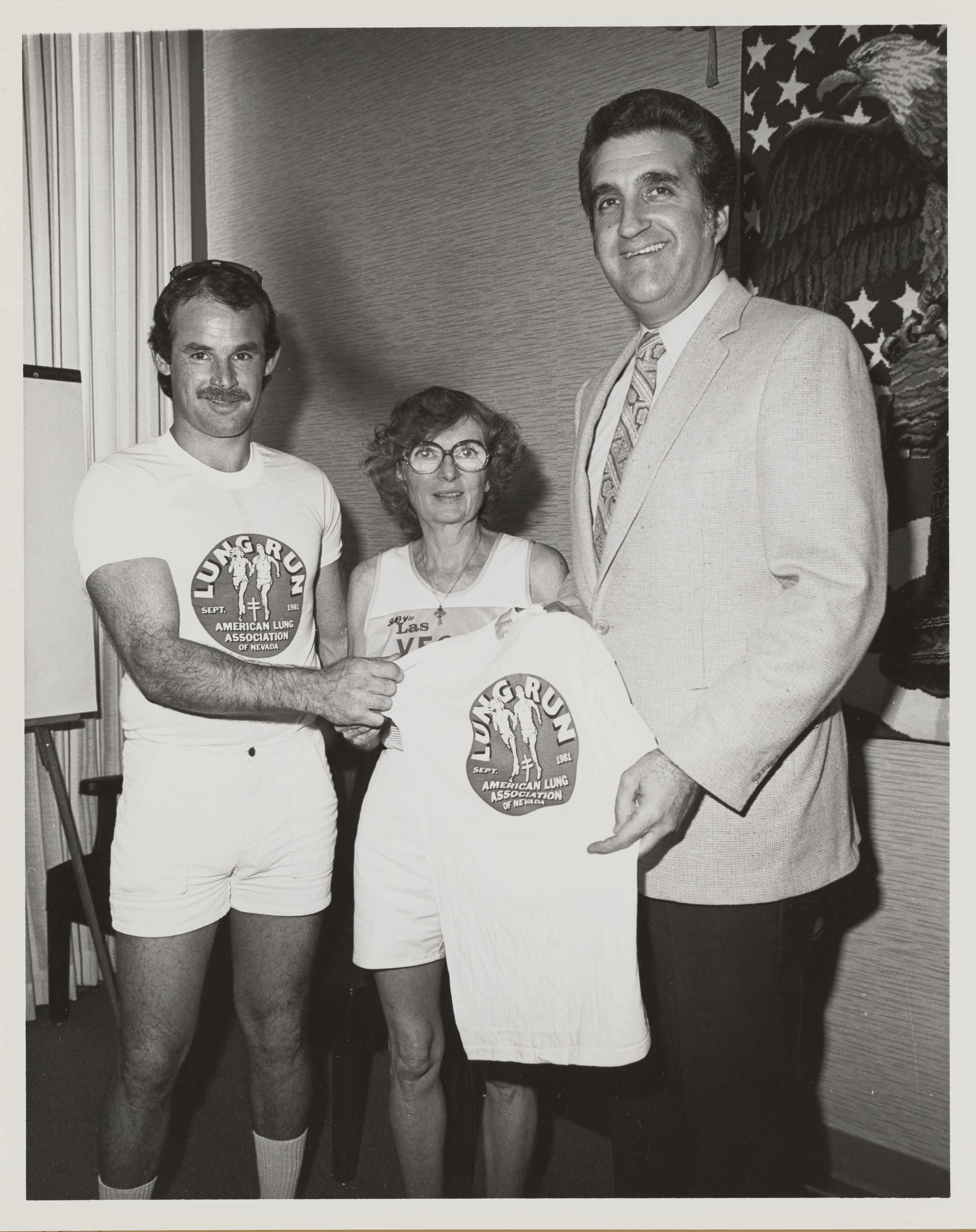 Photograph of Ron Lurie receiving Lung Run t-shirt