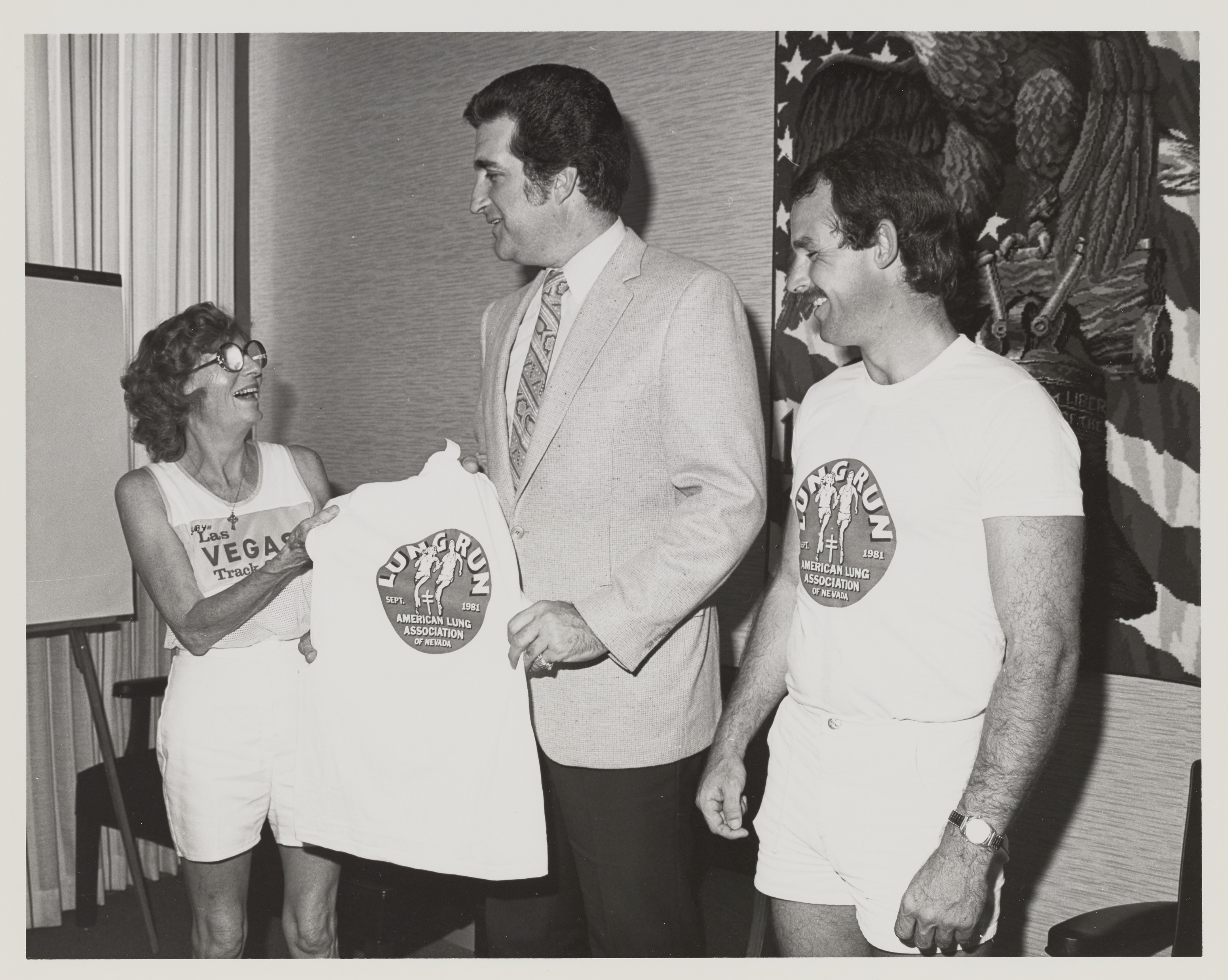 Photograph of Ron Lurie receiving Lung Run t-shirt