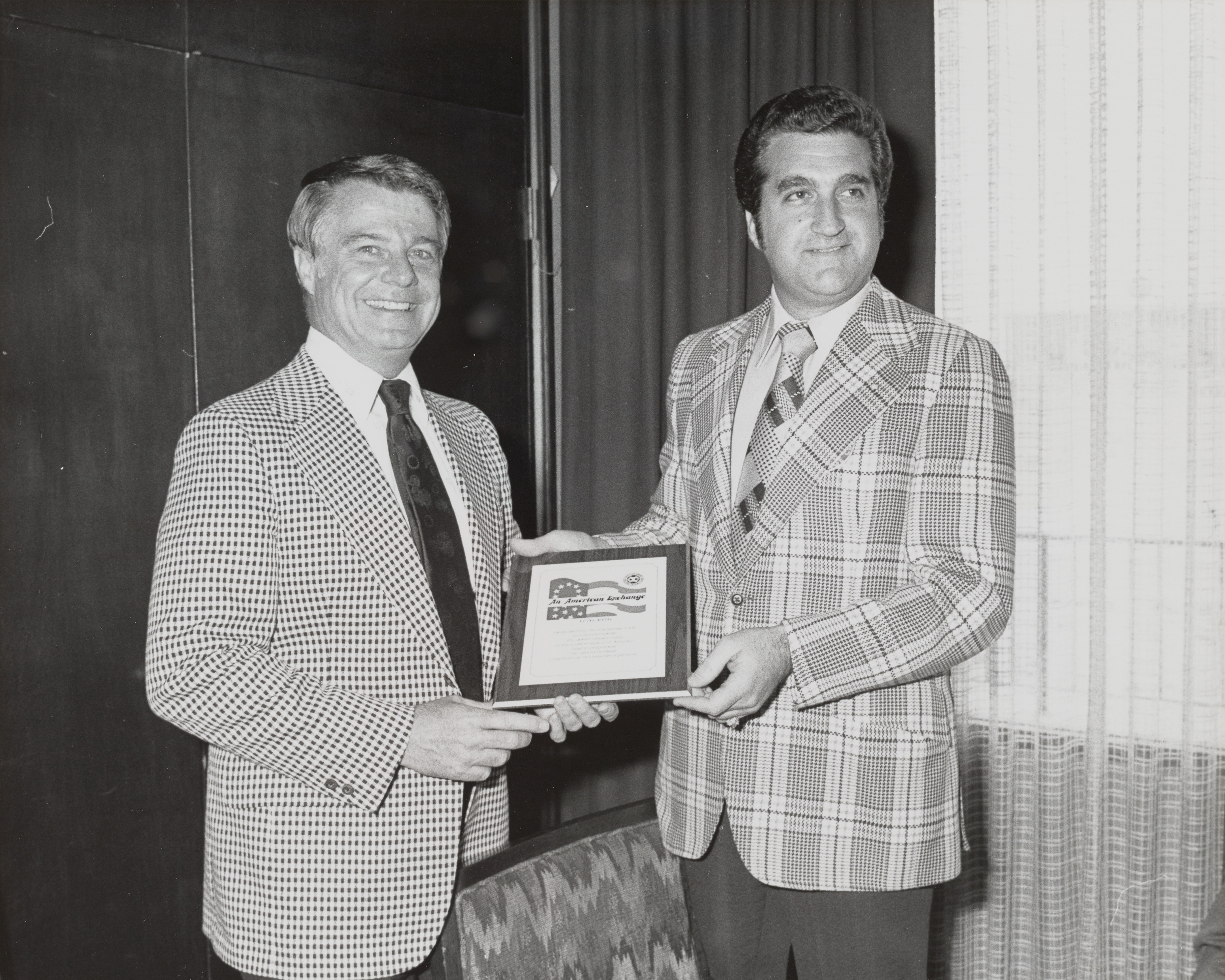 Photograph of Mayor Briare and Ron Lurie with An American Exchange plaque