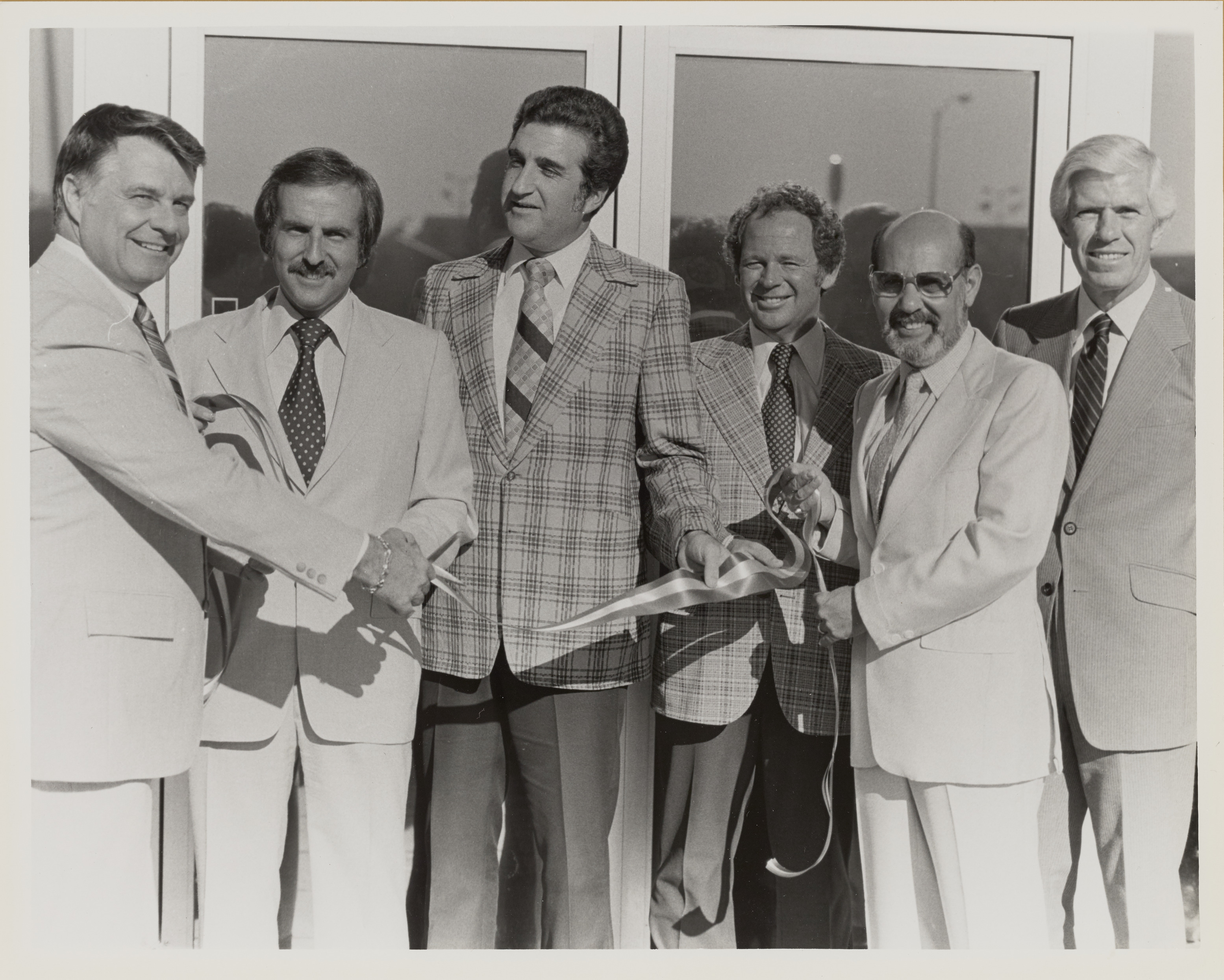 Photograph of  Ron Lurie at ribbon cutting for grand opening of All American Burger