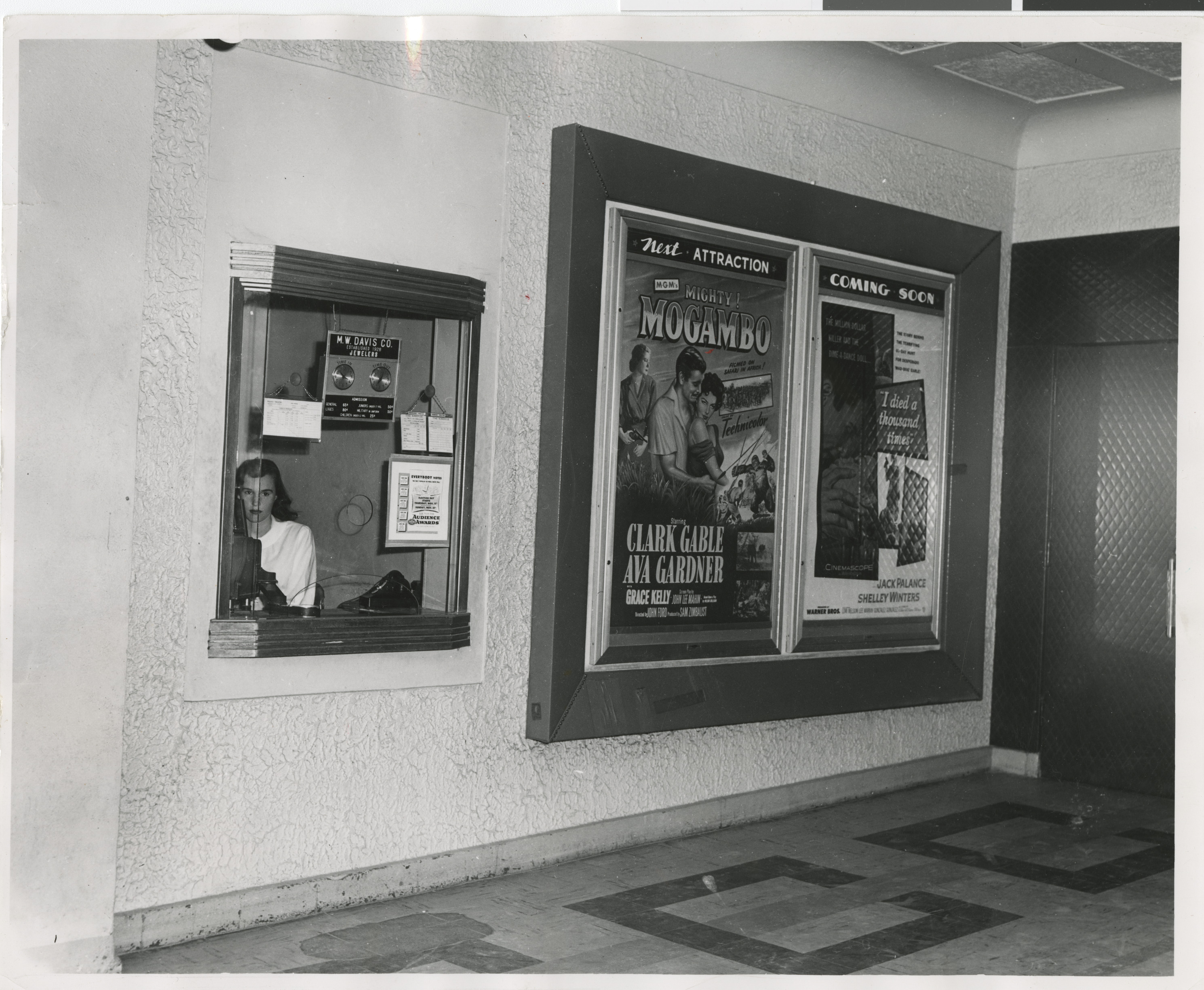 Photograph of interior of Guild Theater billboards and box office