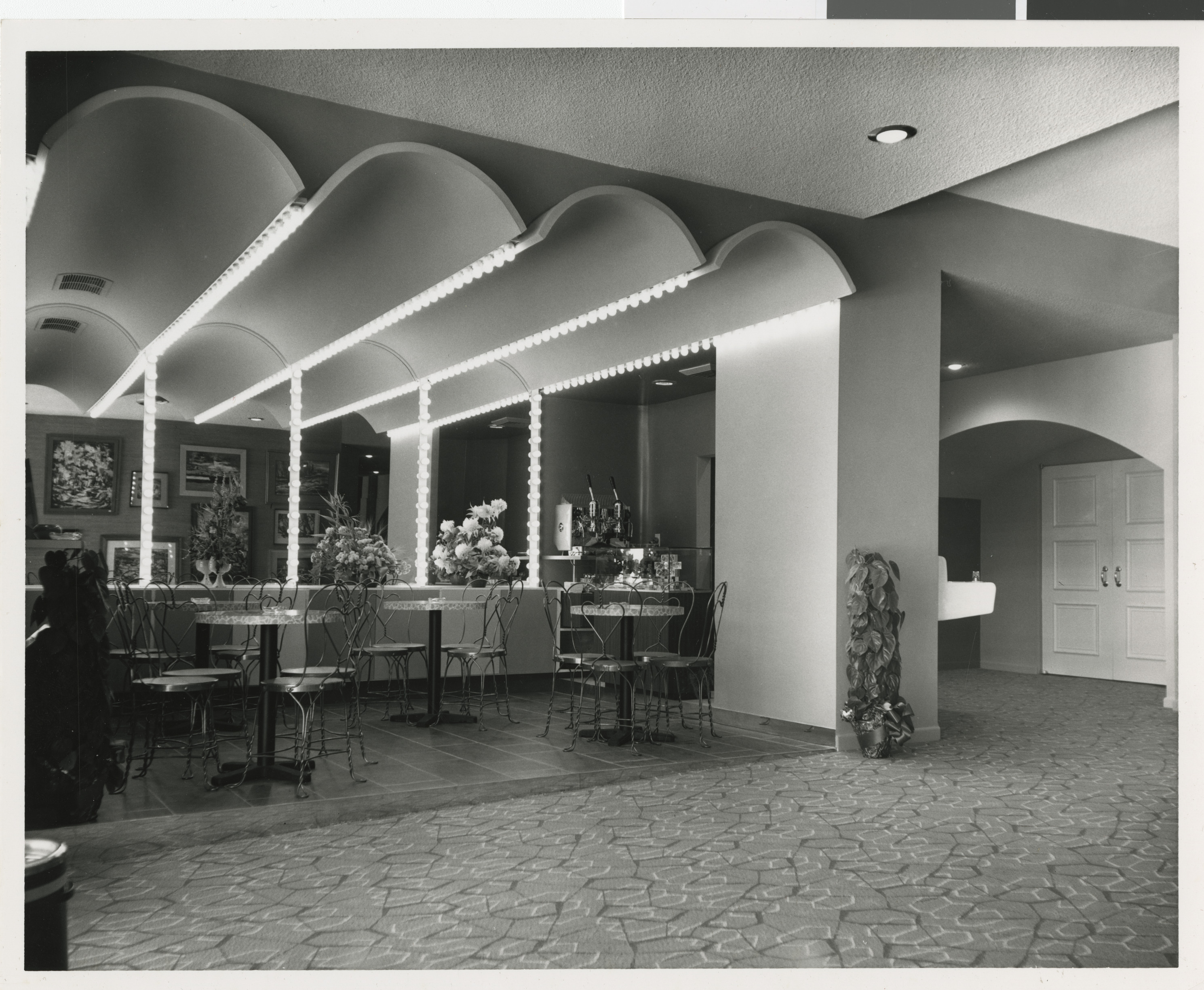 Photograph of interior of Guild Theater lobby and cafe tables