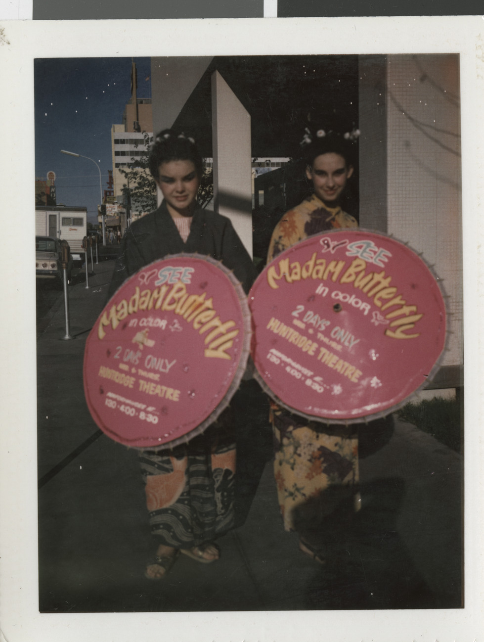 Color photograph of women with parasols advertising Madame Butterfly at the Huntridge Theater