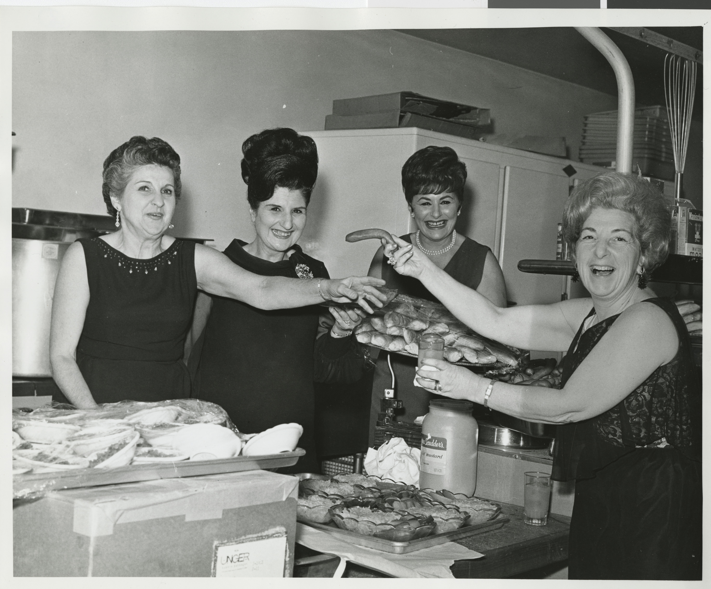 Photograph of Mrs. Carl Cohen birthday party, Lady holding sausage