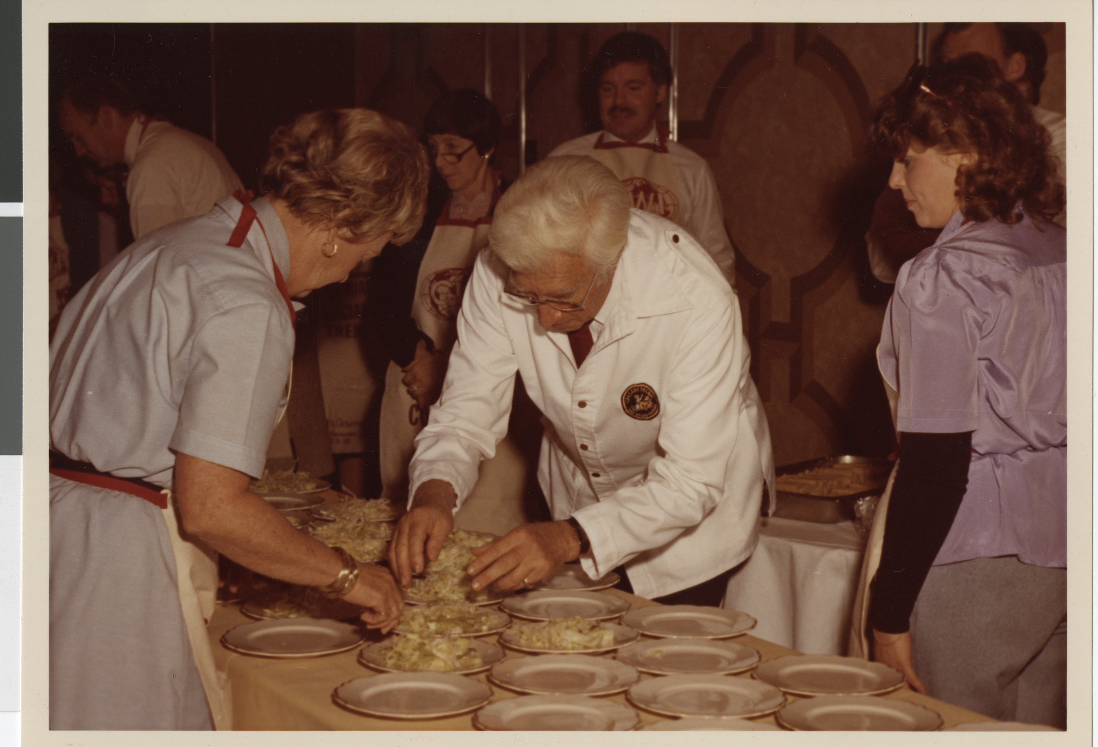 Photograph of Nat Hart assisting a student during a cooking demonstration