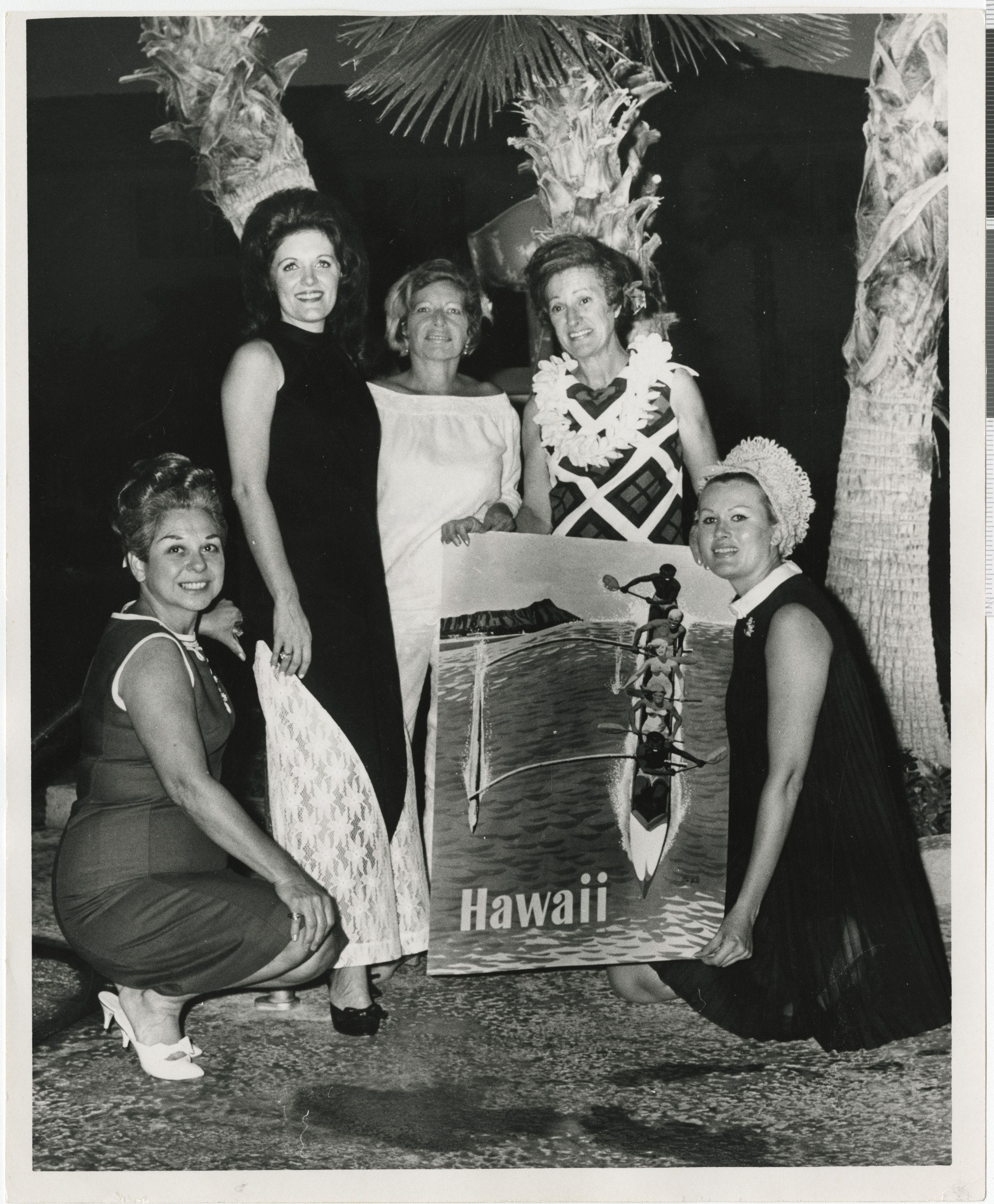 Black and white photograph of five women holding a poster of Hawaii, September 5, 1967