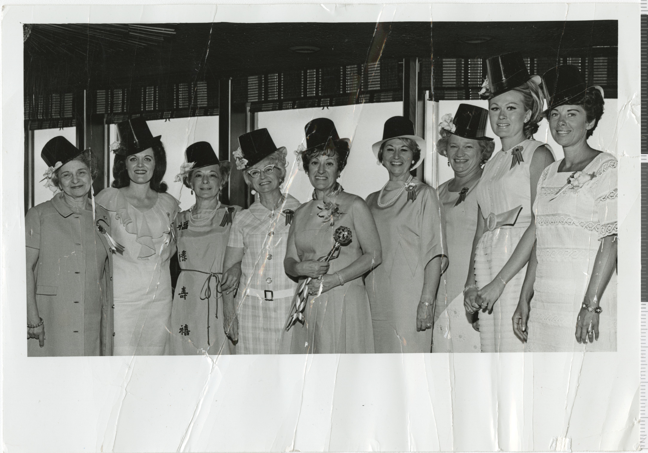 Black and white photo of nine members of Hadassah wearing paper tophats, no date