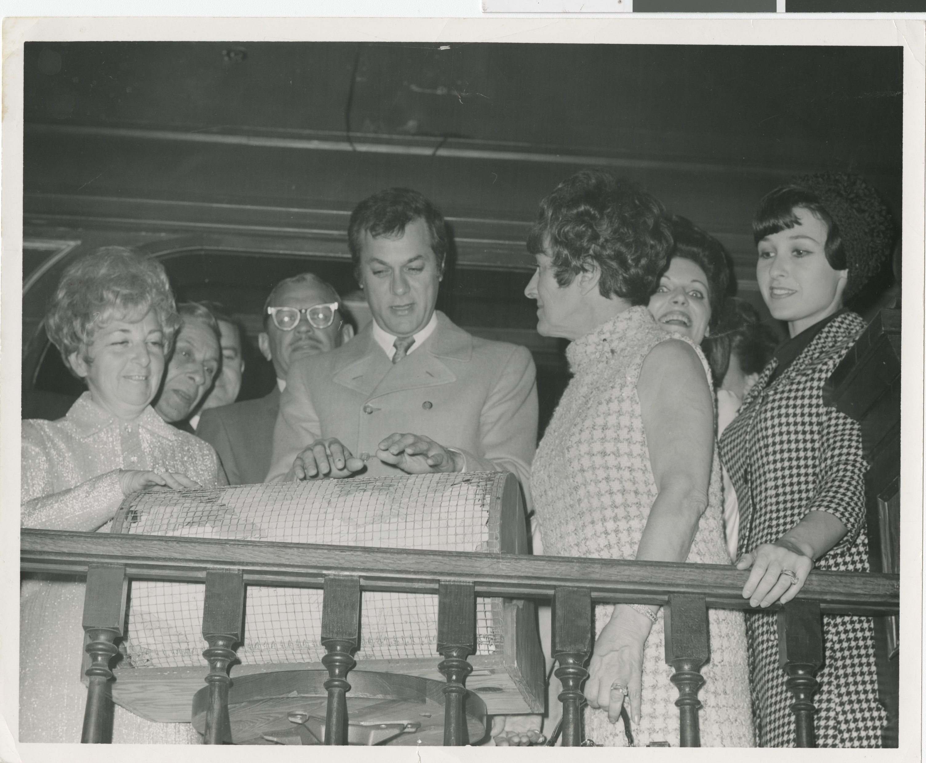 Photograph of Tony Curtis picking winning ticket