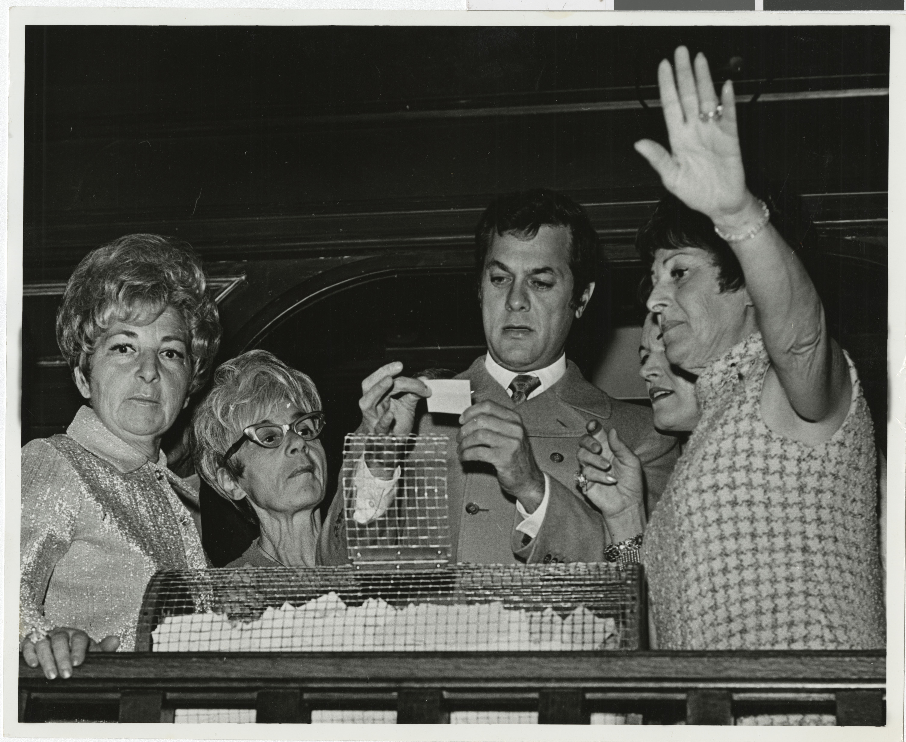 Photograph of Tony Curtis picking winning ticket
