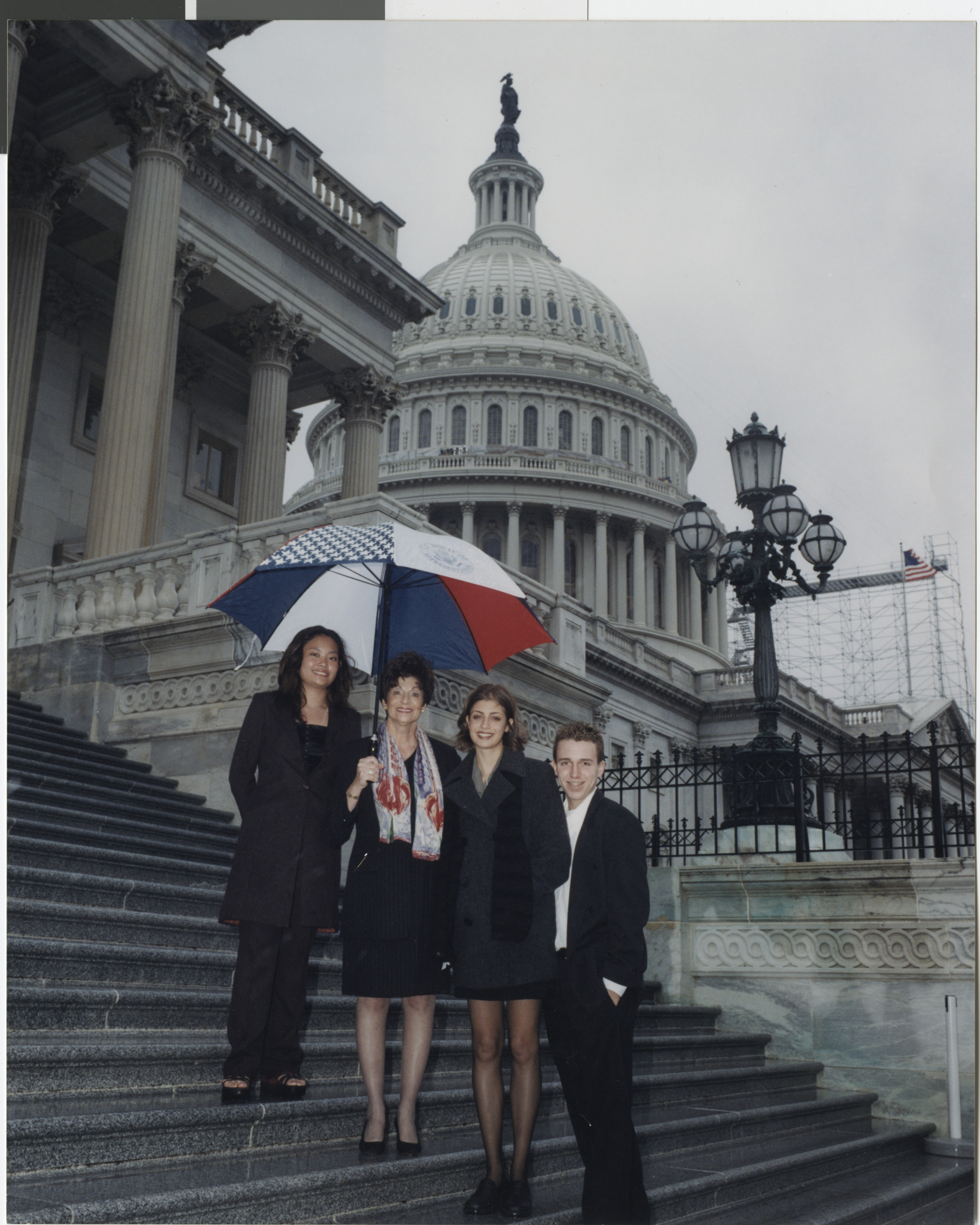 Photograph of Shelley Berkley on the steps of the U.S. Capitol Building with unidentified people, undated