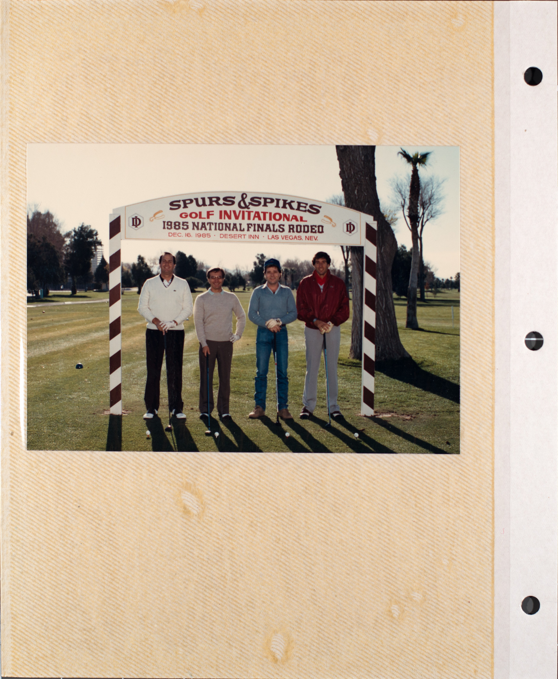 Photograph of Mark Fine and others at the Spurs & Spikes golf invitational, December 16, 1985