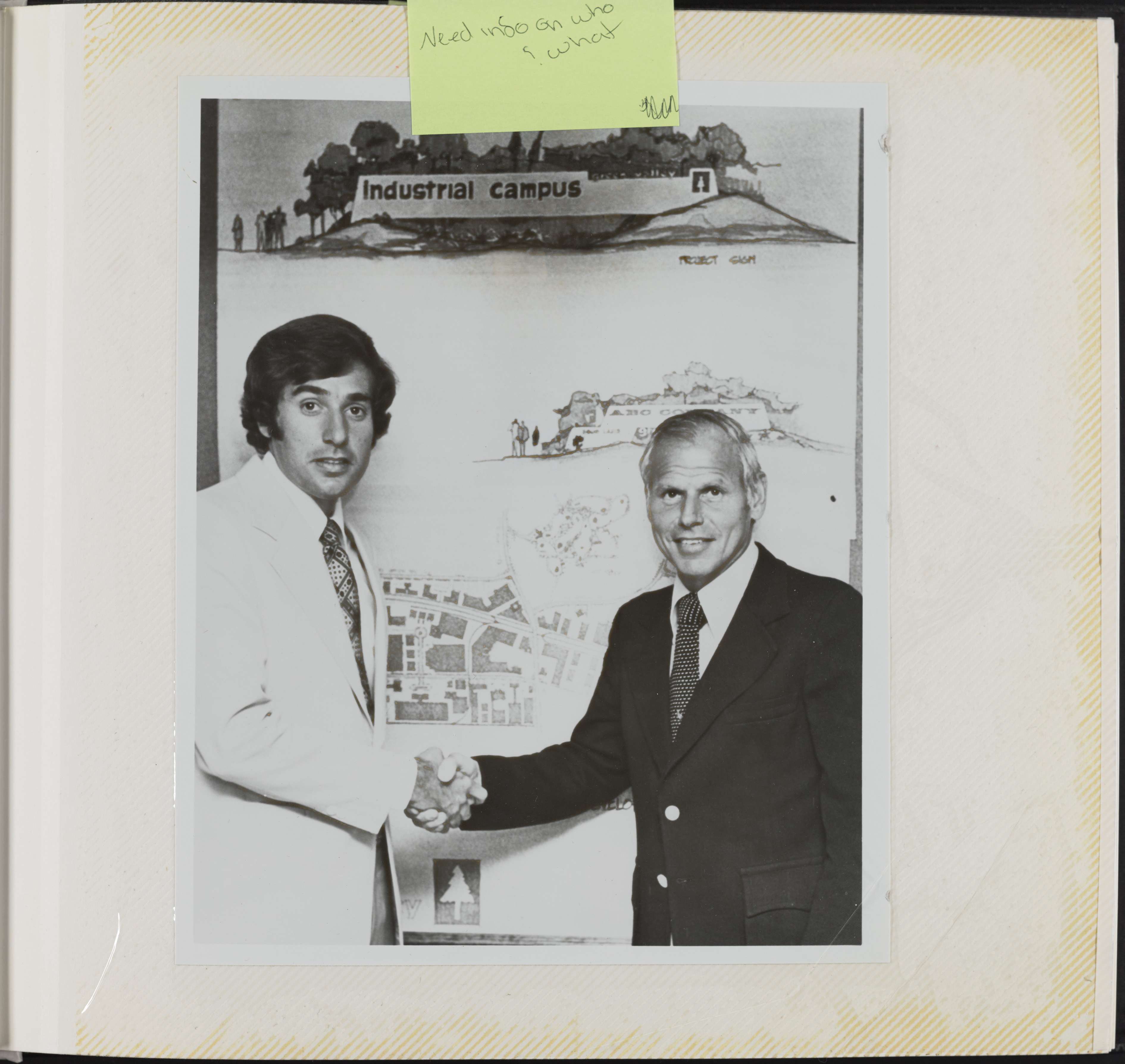 Photograph of Mark Fine shaking hands with unidentified man
