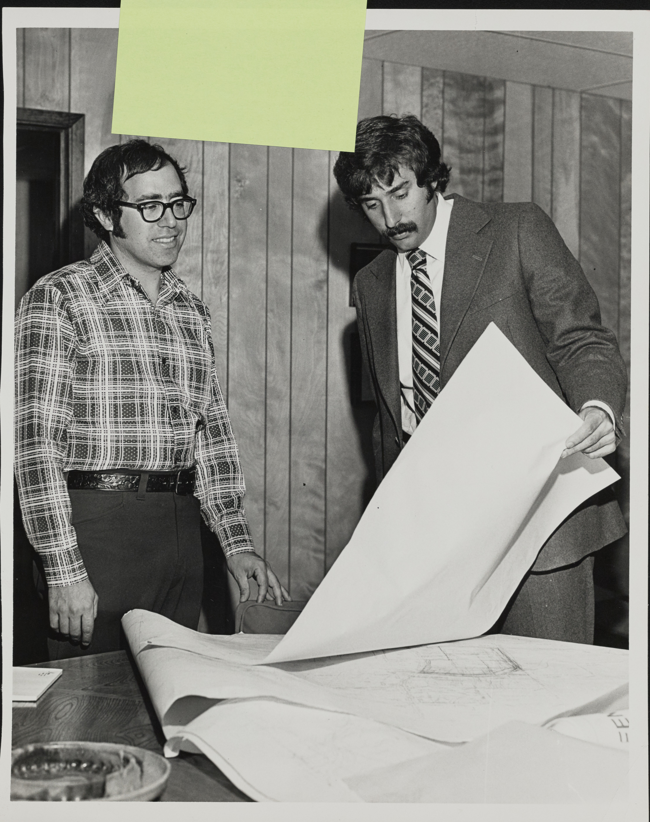 Photograph of Mark Fine with blueprints