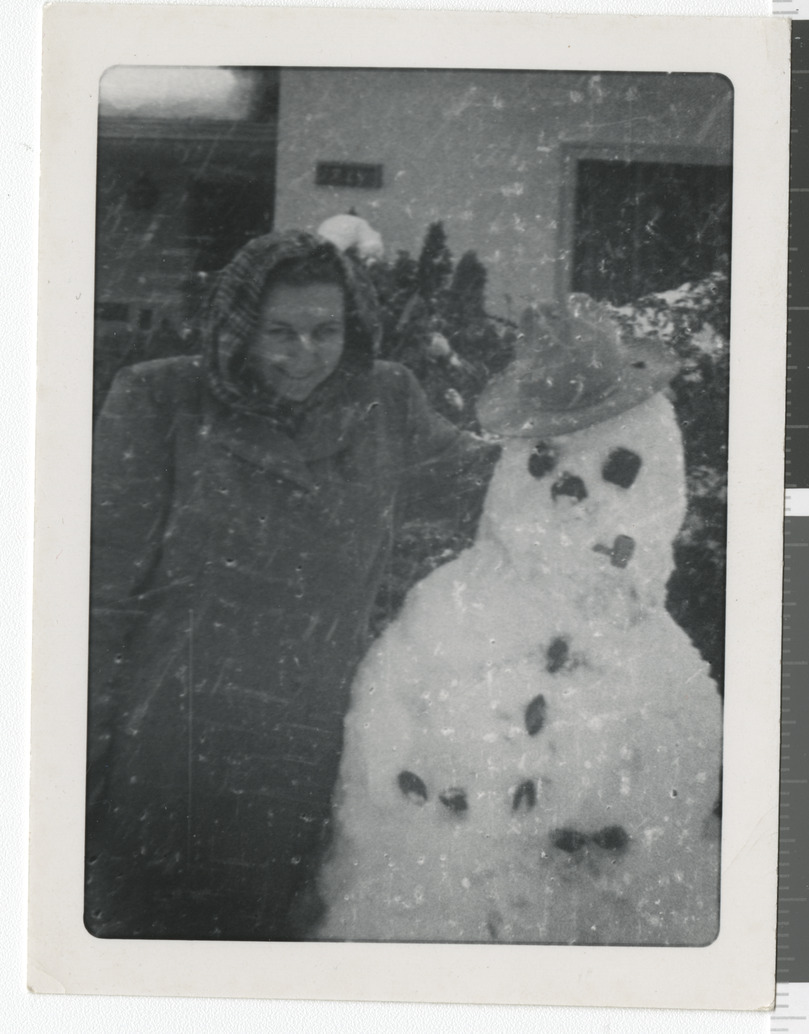 Photograph of Adele Salton (Baratz) with snowman, 9th Street, 1940-1944
