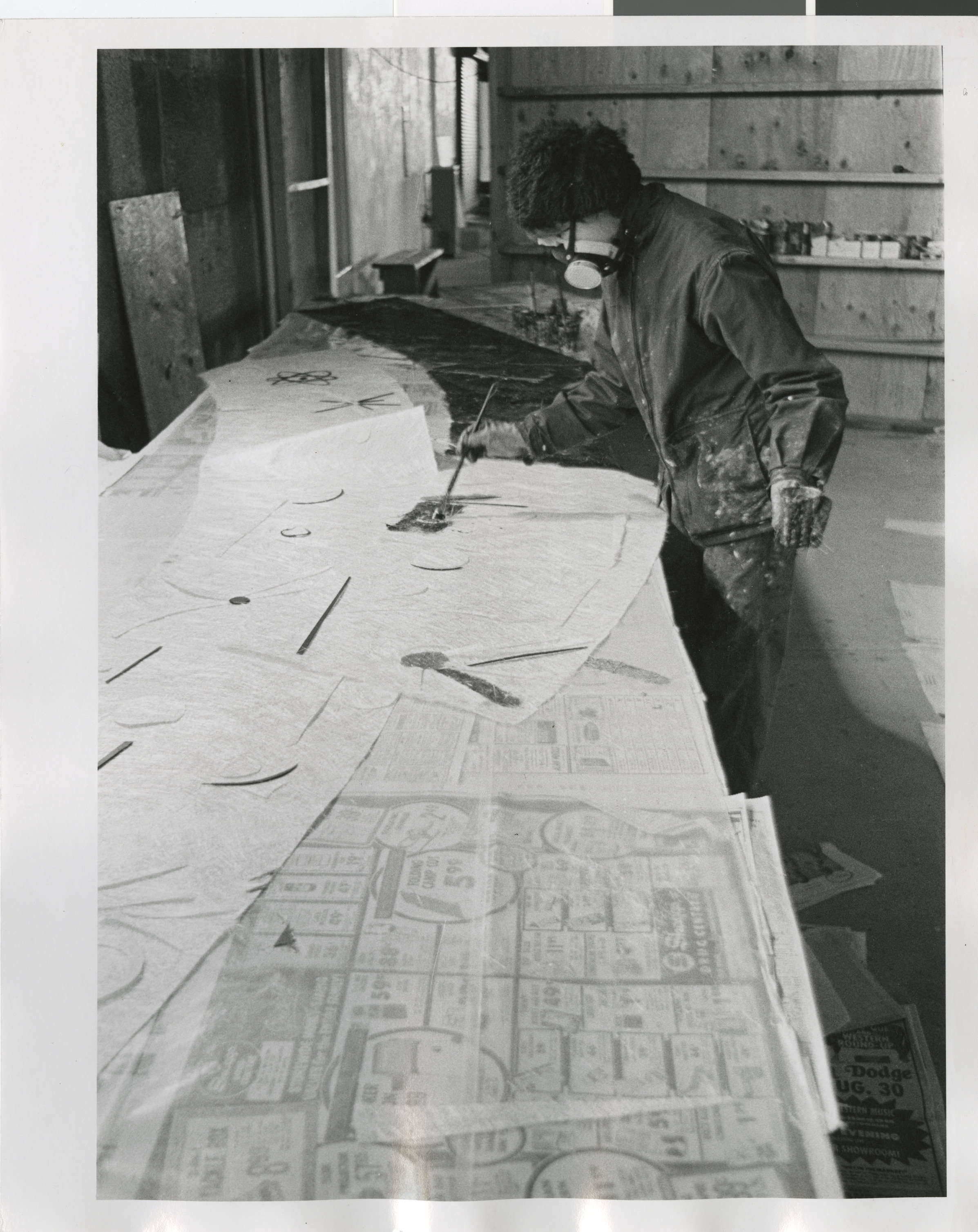 Photograph of Rita Deanin Abbey working on Temple Beth Sholom resin mural, 1970s