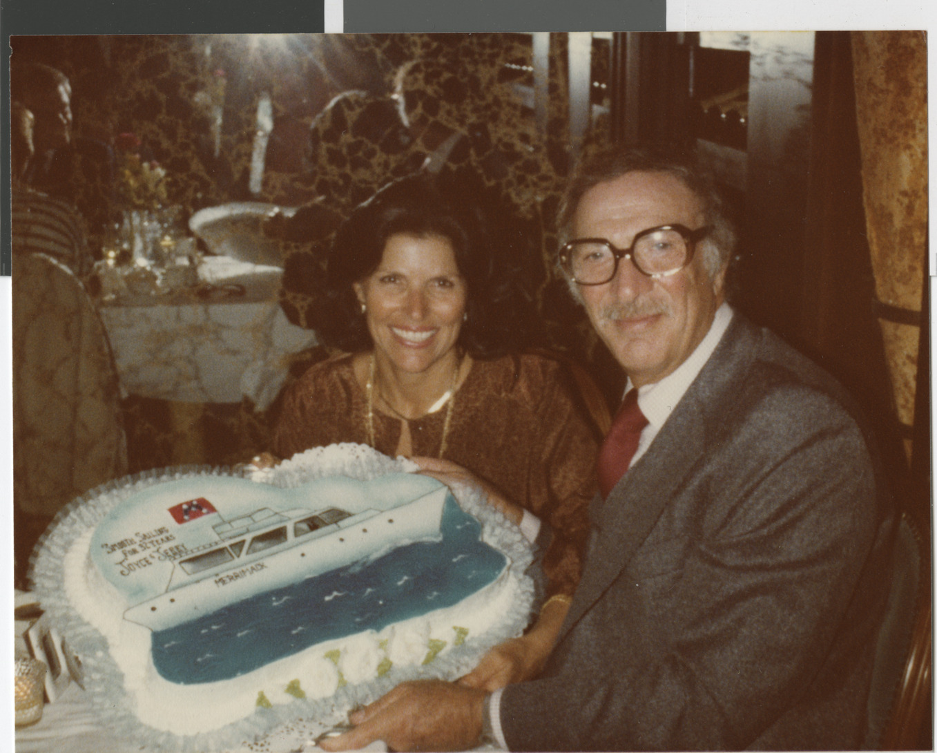 Photograph of Joyce and Jerry Mack with cruise ship cake celebrating their anniversary, March 30, 1979