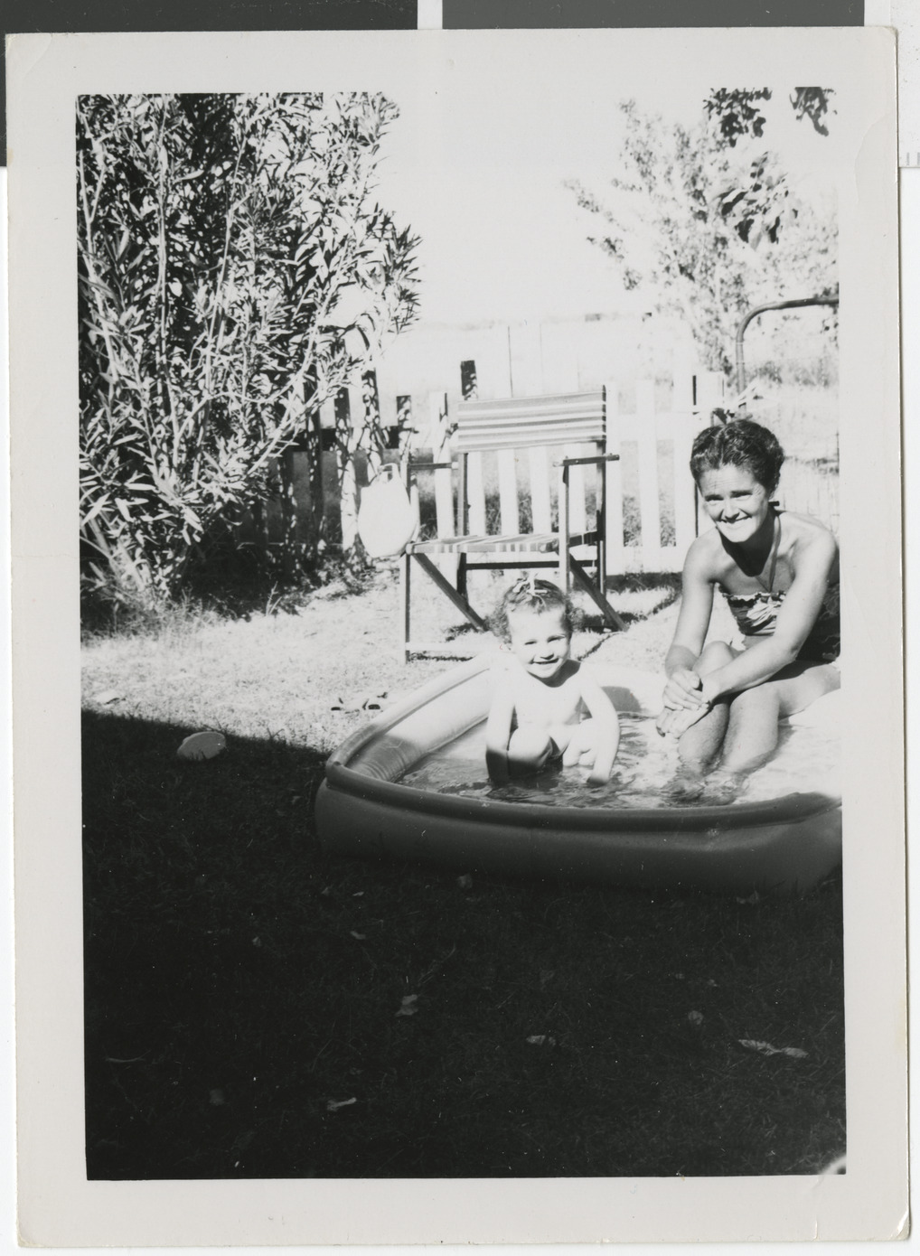 Photograph of Bella Stern with Ruth in swimming pool, circa 1950