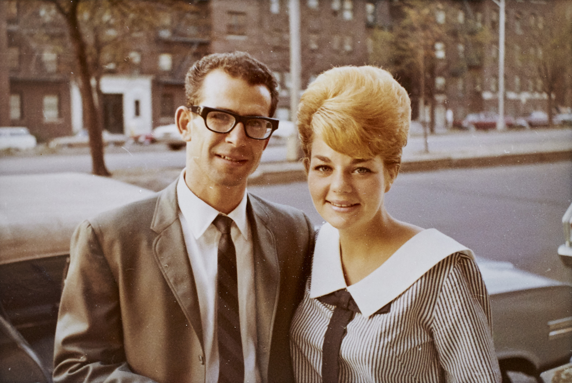 Photograph of David and Iris Torjman outside of apartment building on Grand Concourse, 1966