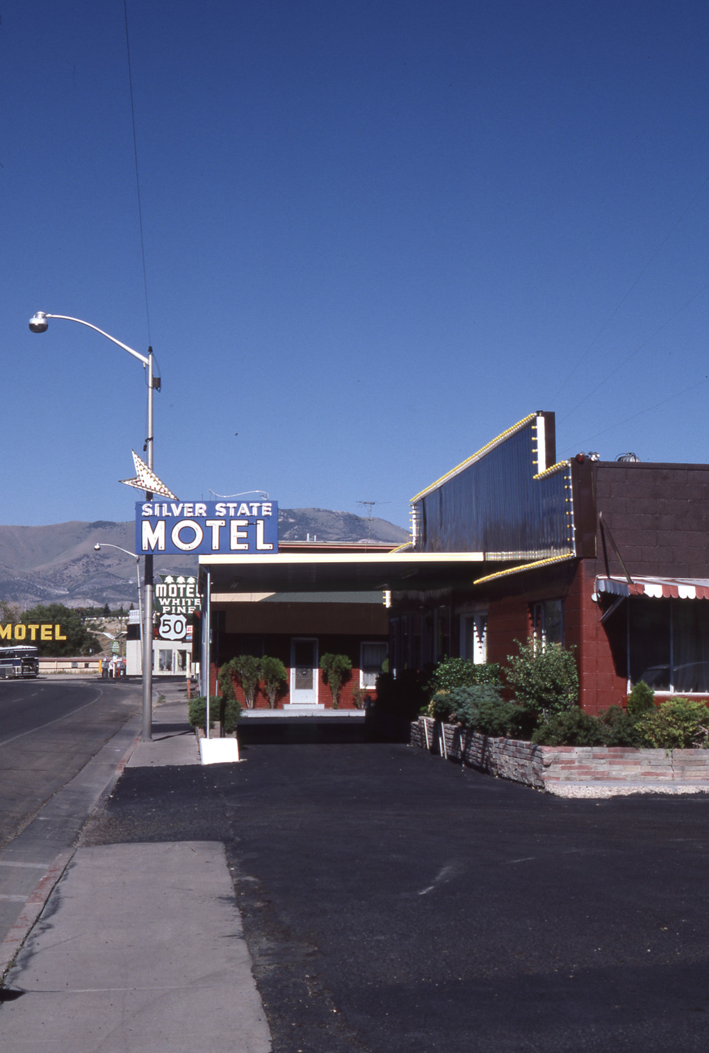 Silver State Motel flag mounted pylon, Ely, Nevada: photographic print