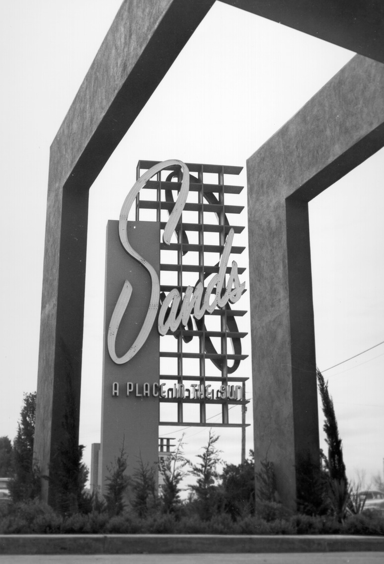 Photograph of the neon sign for the Sands Hotel (Las Vegas) as seen from under the hotel's porte-cochère (Googie architectural design), 1952