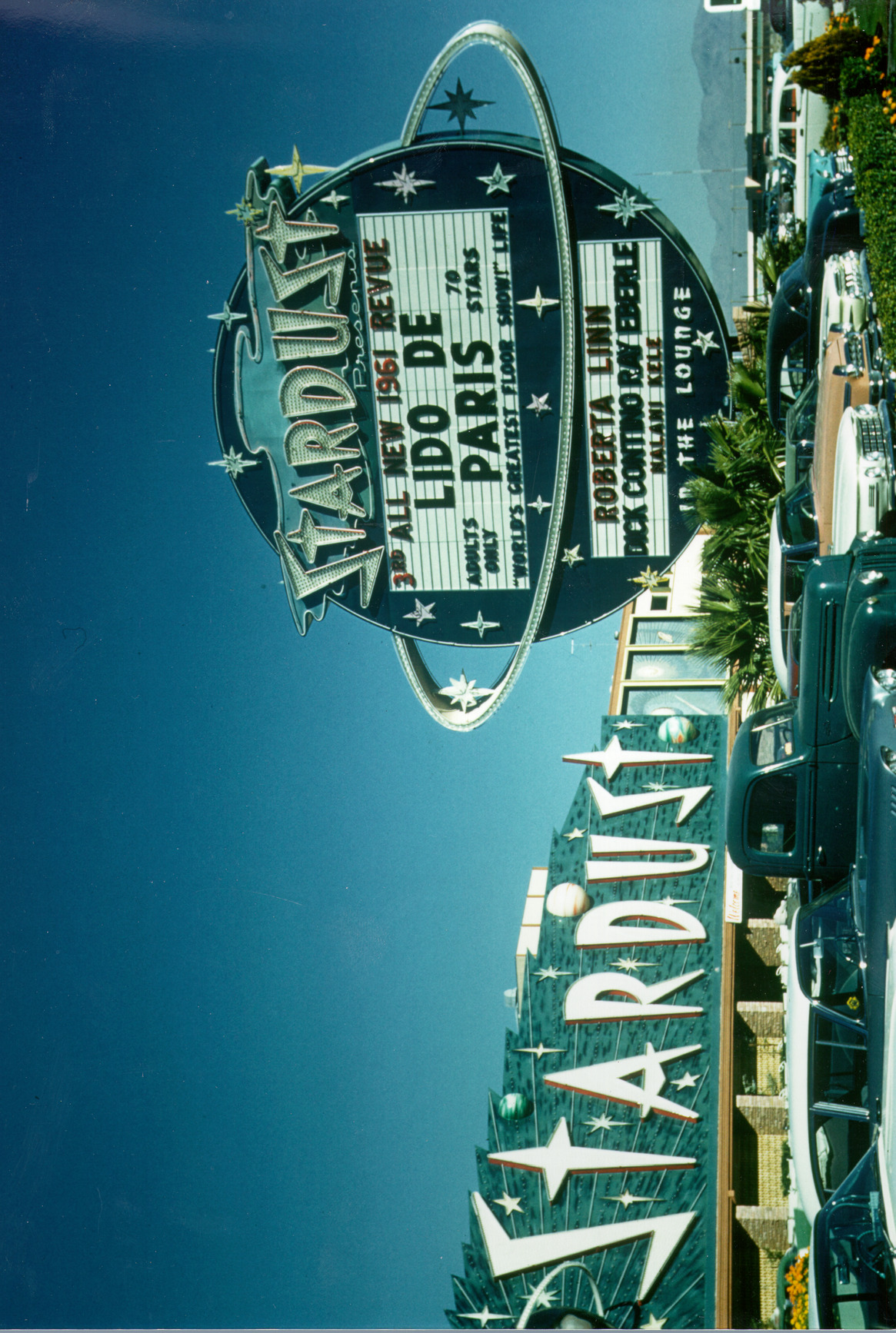 Photograph of the front exterior and parking lot of the Stardust Hotel and Casino (Las Vegas), circa 1961