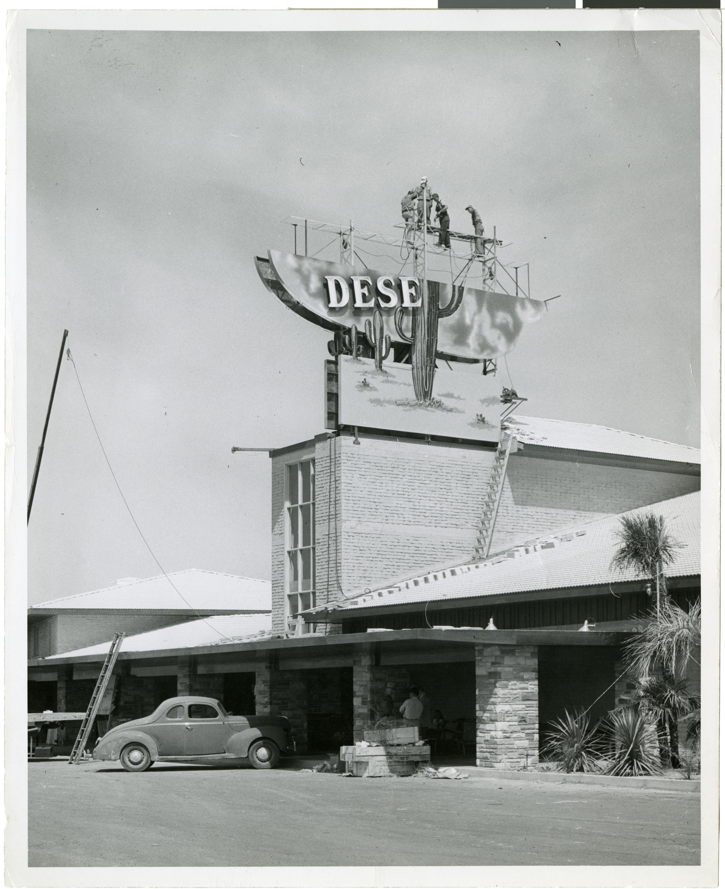 Photograph of workers assembling the sign for Wilbur Clark's Desert Inn (Las Vegas), circa 1950s